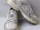 white new balance shoes with white soles on a white background