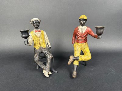 two figurines of a man and a woman sitting on a chair