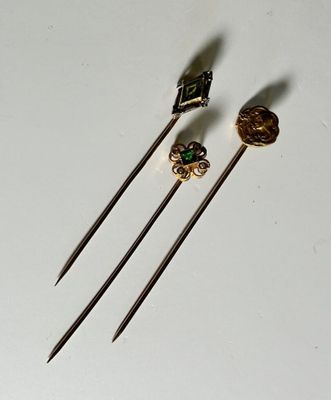 three different types of knitting needles on a white surface