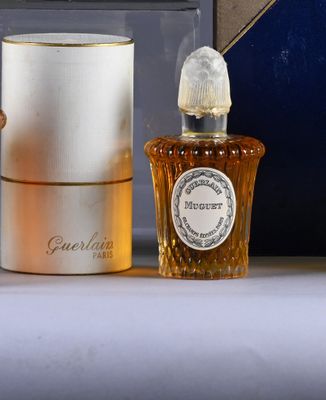 a bottle of perfume next to a box of perfume