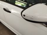 a close up of a car ' s side mirror with a denting on it