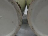 two vases that are sitting next to each other