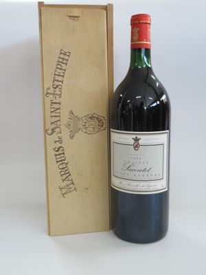 a bottle of wine sitting next to a wooden box