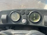 a close up view of a motorcycle ' s dashboard with gauges