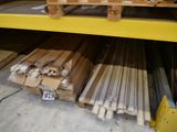 many pieces of wood stacked on a shelf in a warehouse