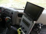 a computer and a game controller in the driver ' s seat of a truck