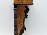 an old wooden shelf with a drawer on top of it