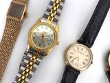 two watches and a wrist watch are sitting on a table