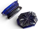 two pieces of blue glass are sitting on a white surface