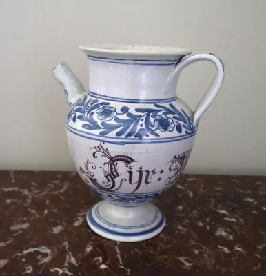 a blue and white vase sitting on top of a table