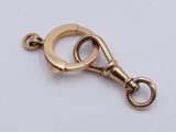 a close up of a gold plated metal clasp on a white background