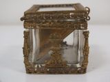 a small glass box with a clock inside of it