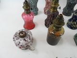 many different colored vases sitting on a white table