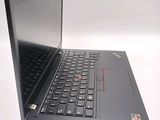 a laptop with a black keyboard on a white surface