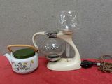a tea pot and a tea kettle on a table