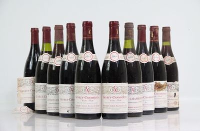 six bottles of wine are lined up in a row on a table