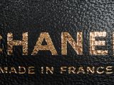 a close up of a black bag with a gold logo on it
