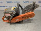 a chainsaw is sitting on the floor in front of a sign