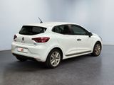 the rear end of a white car parked in a room