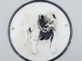 a black and white picture of a pug dog on a plaque