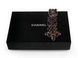 a black box with a red and white broochle on it