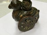 a bronze statue of a man riding a horse with a bird on its back