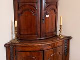 a corner cabinet in the corner of the room