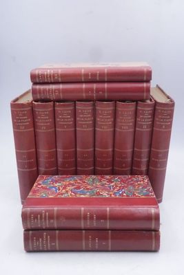 many books stacked on top of each other on a chair