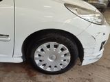 a picture of a white car with a denting wheel
