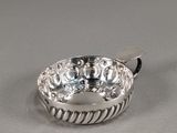 a close up of a silver ring on a white surface