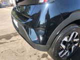 a close up of a black car parked in a parking lot