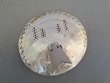 a white plate with a bird on it on a table