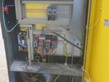 a yellow cabinet with wires and wires in it