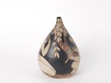 an image of a black and white vase sitting on a white surface