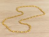 a gold chain on a wooden surface