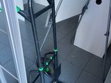 a black hand truck with a green handle in a bathroom