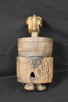 an old wooden bell with a bird on top of it on a black background
