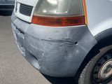 a white van that has been vandalized and is parked in a parking lot