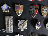 many different types of badges on a black surface