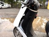 a scooter that is parked on the side of the road