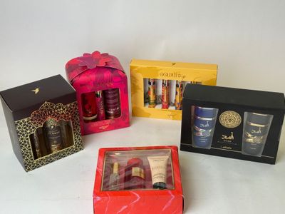four different types of perfumes in boxes on a white surface