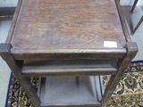 a small wooden table with a shelf on top of it