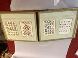two framed pictures of chinese writing on the wall