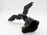 statue of a bird on a shell on a white background