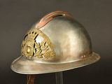 a silver helmet with a gold emblem on it