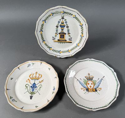 three plates with designs on them are sitting on a table