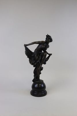 bronze figurine of a woman with a bow on a pedestal
