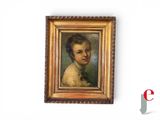 portrait of a young boy in a gold frame with a black bow tie
