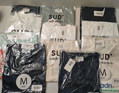a lot of shirts that are sitting on a shelf