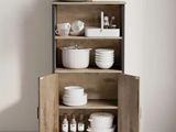 a wooden cabinet with dishes and bowls on it